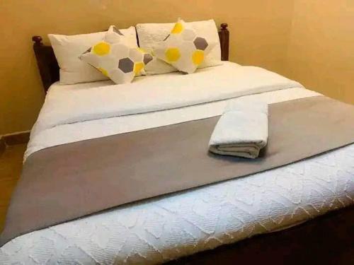a bed with two pillows and a towel on it at Villa Serene Hotel Kitale in Kitale