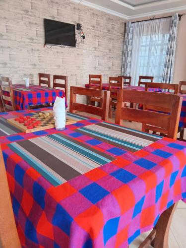 a room with a colorful blanket on a table at Villa Serene Hotel Kitale in Kitale