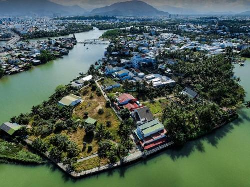 an island in the middle of a river with houses at Pepper In Nha Trang Homestay in Nha Trang