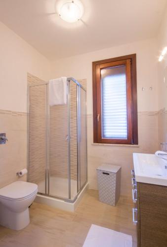 a bathroom with a shower and a toilet and a sink at La Perla dello Stagnone in Birgi Vecchi