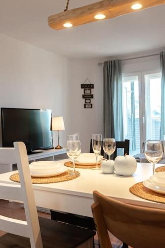 a dining room with a table with wine glasses at Moraima parking incluido in Sierra Nevada