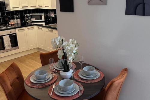 a dining room table with plates and dishes on it at 2Bed Apartment-Free Parking Pets Garden Central in London