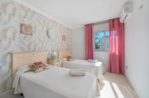 En eller flere senge i et værelse på Apartamento Adriana