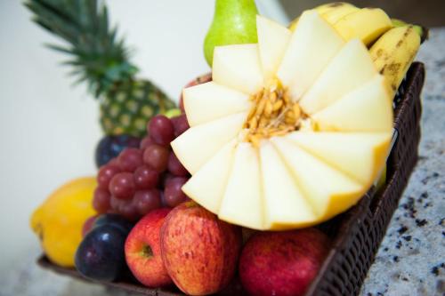 a basket filled with fruits and vegetables on a table at Italian Palace Hotel in Palmas