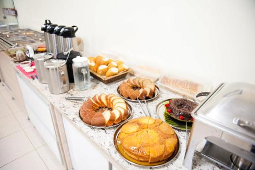 a kitchen counter with many different types of food on at Italian Palace Hotel in Palmas