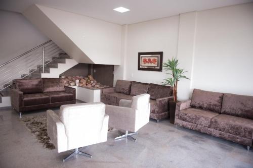 a living room with couches and a fire place at Italian Palace Hotel in Palmas