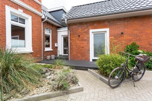a bike parked in front of a brick house at Pier17 Appartement 3 in Borkum