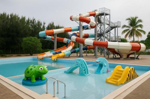 a pool with a water slide in a park at JAZ Elite Aurora in Michamvi