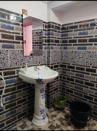 a bathroom with a sink and a mirror at Sreemoyee Homestay in Hatikhuli