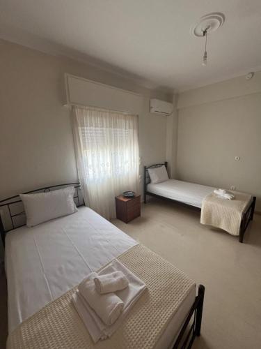 a bedroom with two twin beds and a window at Marina's house in Preveza