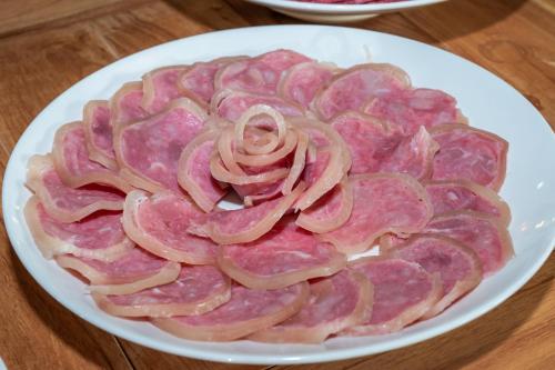 a plate of thinly sliced meat on a table at Asia Tropical Resort and Spa in Làng Coc