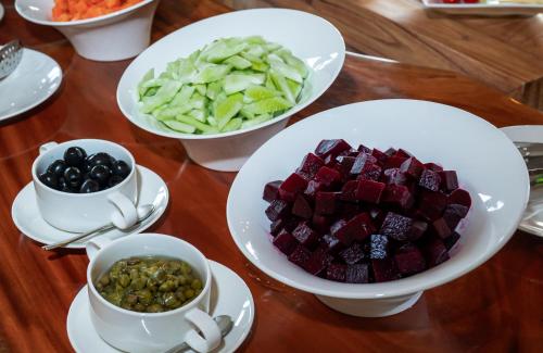 a table with plates of food and bowls of vegetables at Asia Tropical Resort and Spa in Làng Coc