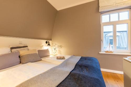 Una cama o camas en una habitación de Logierhaus K15 Appartement 9 Plus