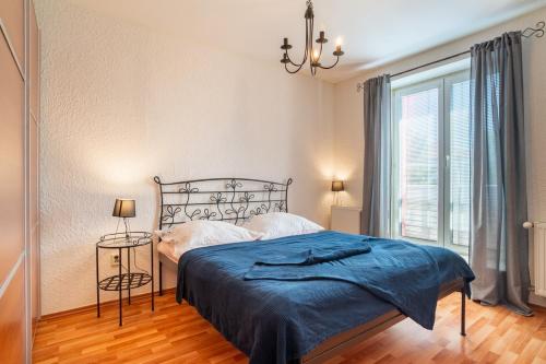 a bedroom with a bed and a large window at Comfy 1BR Apartment in Otilia