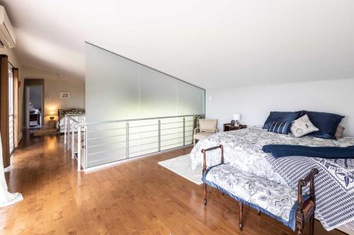 a bedroom with a bed and a large glass wall at Riverside - Spa - Le Laurentien in Saint-Antoine-Lotbinière
