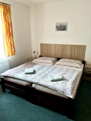 a bedroom with a bed with two pillows on it at Pension Bystřenka in Špindlerův Mlýn