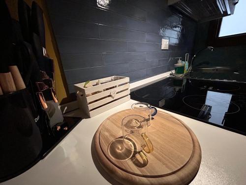 a wooden table with a pair of glasses on a counter at Suite del Lago LuxuryRoom in Biccari