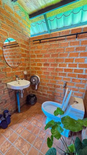 a bathroom with a toilet and a sink at DeeTorJai FarmStay Nan ดีต่อใจ ฟาร์มสเตย์ น่าน โดยเจ้าของ in Ban Klang