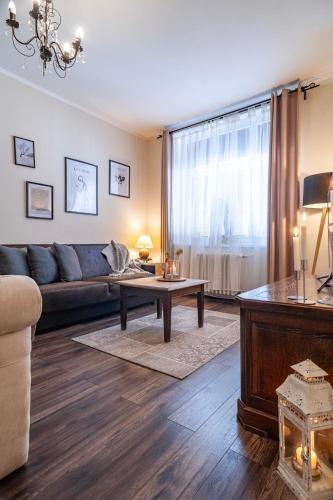 a living room with a couch and a table at STING Boutique Apartments in Ostrava