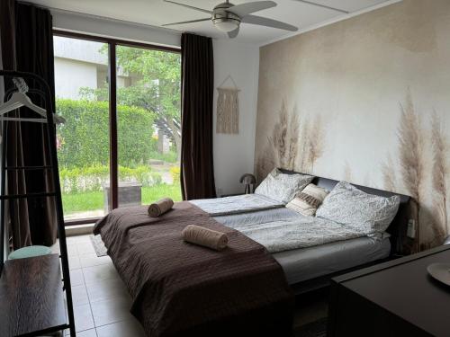 a bedroom with a bed and a large window at Villa Rada, Bay View Villas in Kosharitsa