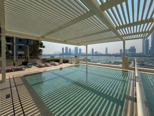 a swimming pool on the roof of a building at Luxury 3BR Palm Views at Emaar Beachfront in Dubai