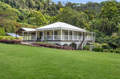 a white house with a lawn in front of it at Montville Retreat offgrid luxury in Montville