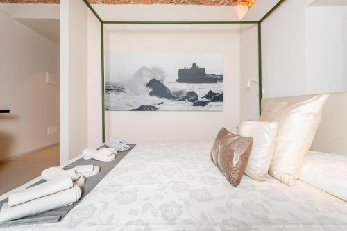 a bedroom with a bed with a painting on the wall at Spazio Pardo in Catania