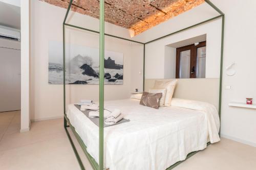 a bedroom with a bed with a glass wall at Spazio Pardo in Catania