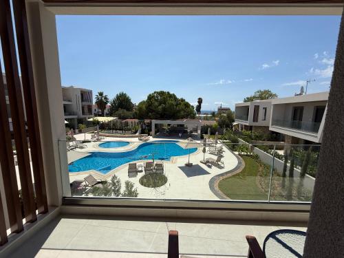 a view of a swimming pool from a balcony at Darion Luxury Villa Nikiti Chalkidiki in Nikiti