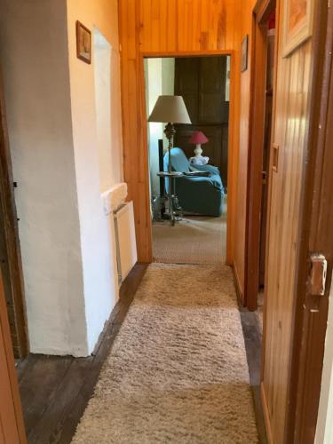 a hallway with a door leading into a room at Ferme du XVIIe siècle restaurée 120 m2 in Goutrens