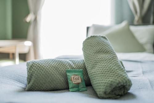 two pillows and a cup on a bed at HOME1 - Augarten City Stay Boutique Hostel in Vienna