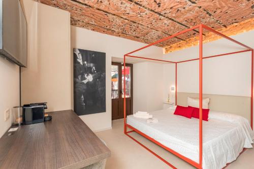 a bedroom with a canopy bed and a tv at Spazio Pardo in Catania