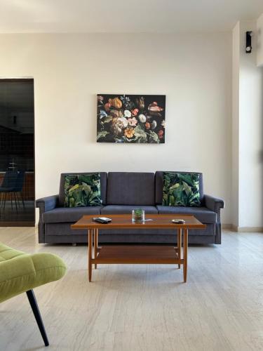 a living room with a couch and a coffee table at DREAM & HARMONY in Artemida