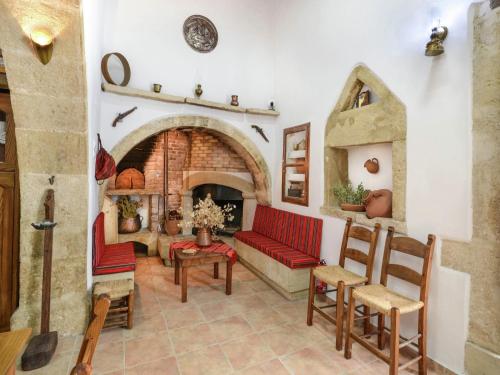 a living room with a couch and a fireplace at Villa in Crete with Vineyard Experience in Kalamítsion Alexándrou