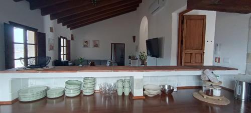 a kitchen with a bunch of plates on the floor at Cortijo J&S Juan Salvador in Málaga