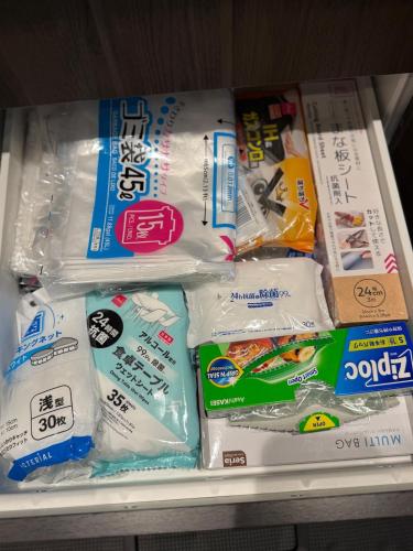 a display of toothushes in plastic bags on a shelf at 一棟貸し宿 ｍａｉｃｃａ in Numazu