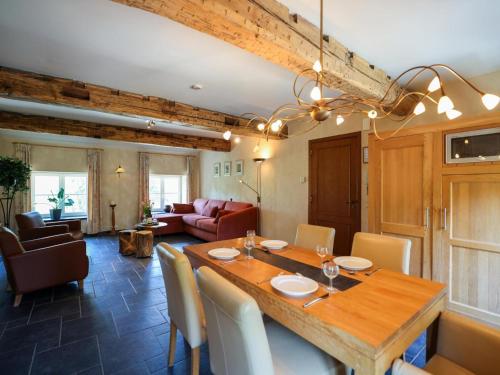 a dining room with a wooden table and chairs at Castle Apartment Aywaille near River Amblève in Aywaille