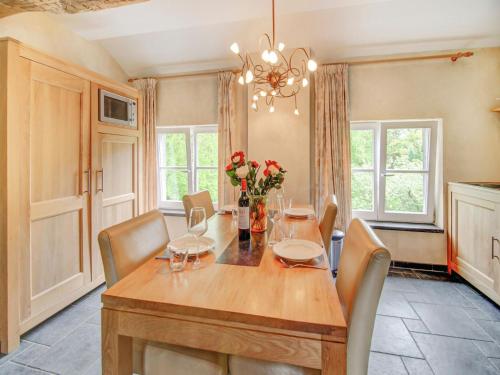 a dining room with a wooden table and chairs at Castle Apartment Aywaille near River Amblève in Aywaille