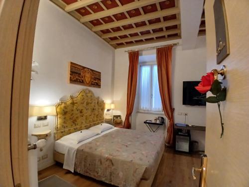 a bedroom with a bed and a large window at Excellent Trinity Rooms in Rome