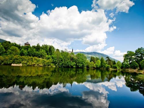 a view of a lake with trees and clouds at Chalet in Hohentauern near Ski Lift in Hohentauern