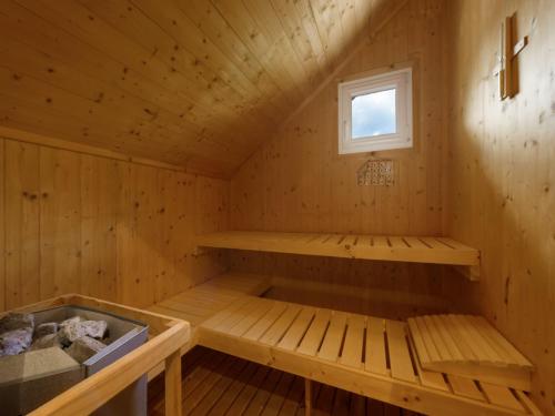 a sauna with a bench and a window at Chalet in Hohentauern near Ski Lift in Hohentauern