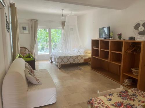 a living room with a bed and a couch at Pointe Aux Biches Villa in Pointe aux Biches