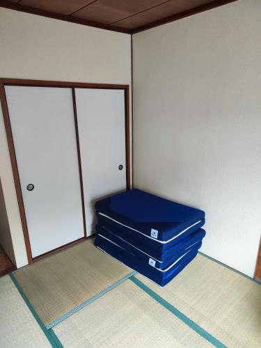 two blue suitcases sitting on the floor in a room at さんこ戸建て1号棟 in Takamatsu