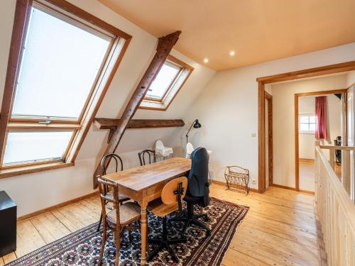 a room with a table and chairs and windows at Holiday home Het Zuidgoed with garden in Aartrijke
