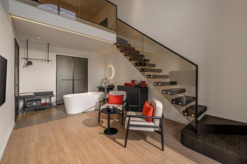 a bathroom with a staircase and a bath tub at Caro Premium Danang Hotel in Da Nang