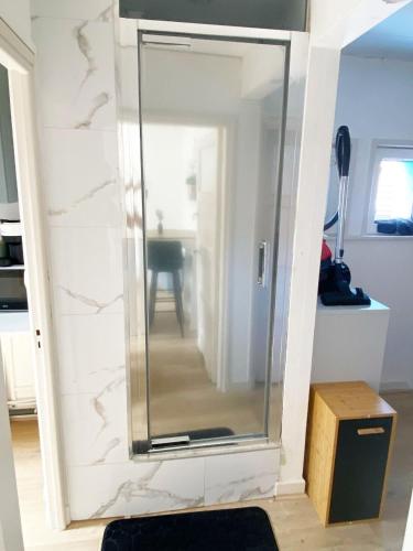 a glass mirror on a wall in a room at Chambre privée à 50 m de la plage- Parking privé, salle de bain et cuisine commune in Le Portel