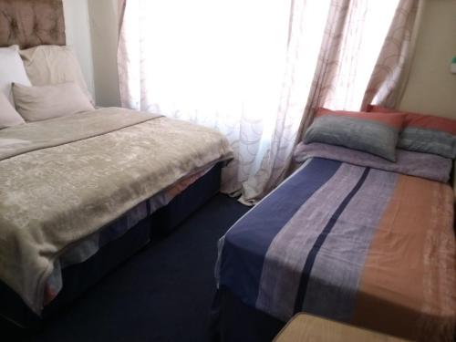 Cama o camas de una habitación en Nsk Guest House Alberton