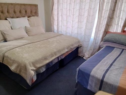 Cama o camas de una habitación en Nsk Guest House Alberton