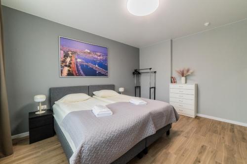 a bedroom with a bed and a painting on the wall at Svečių namai Imperija in Šiauliai