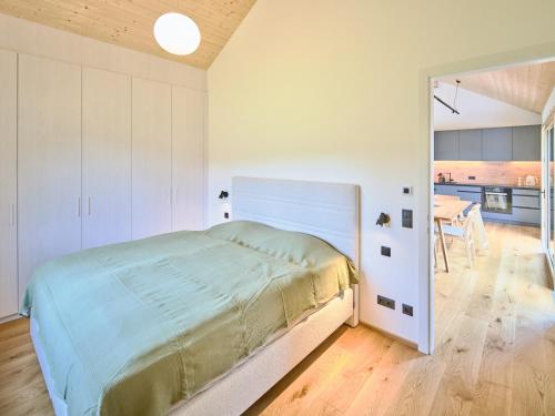 a bedroom with a bed and a dining room at Chalet Hochsteiermark in Mariazell